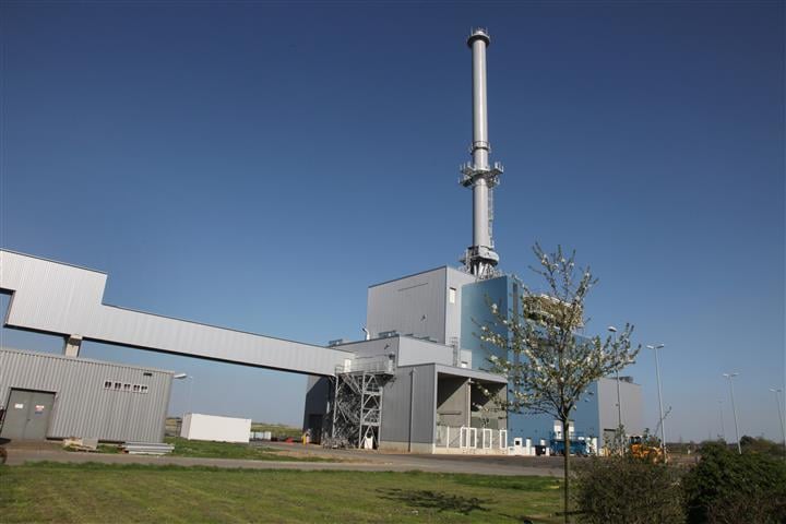 A CHP plant is framed against a clear blue sky.