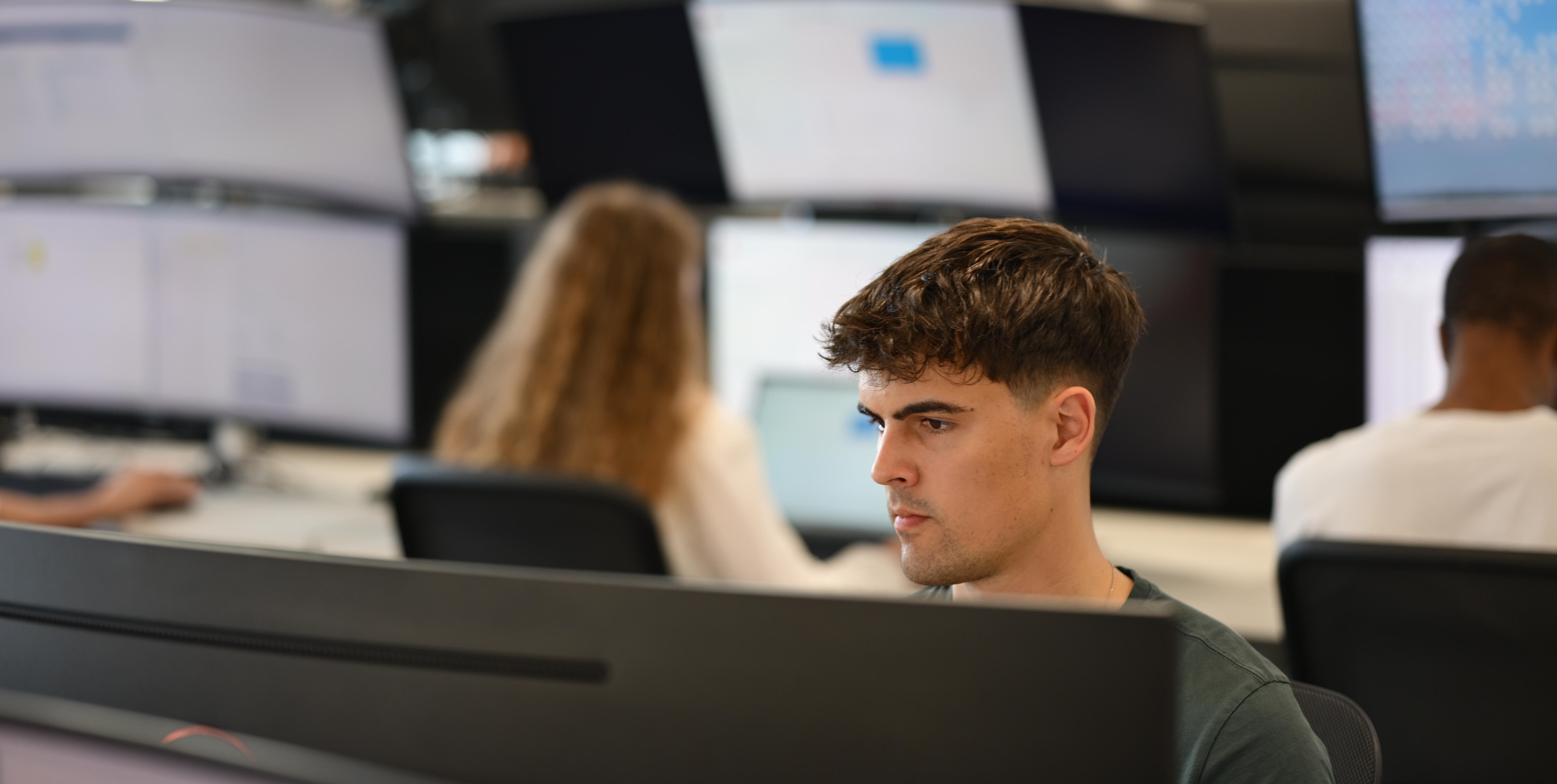 Person looking at screen in office environment.
