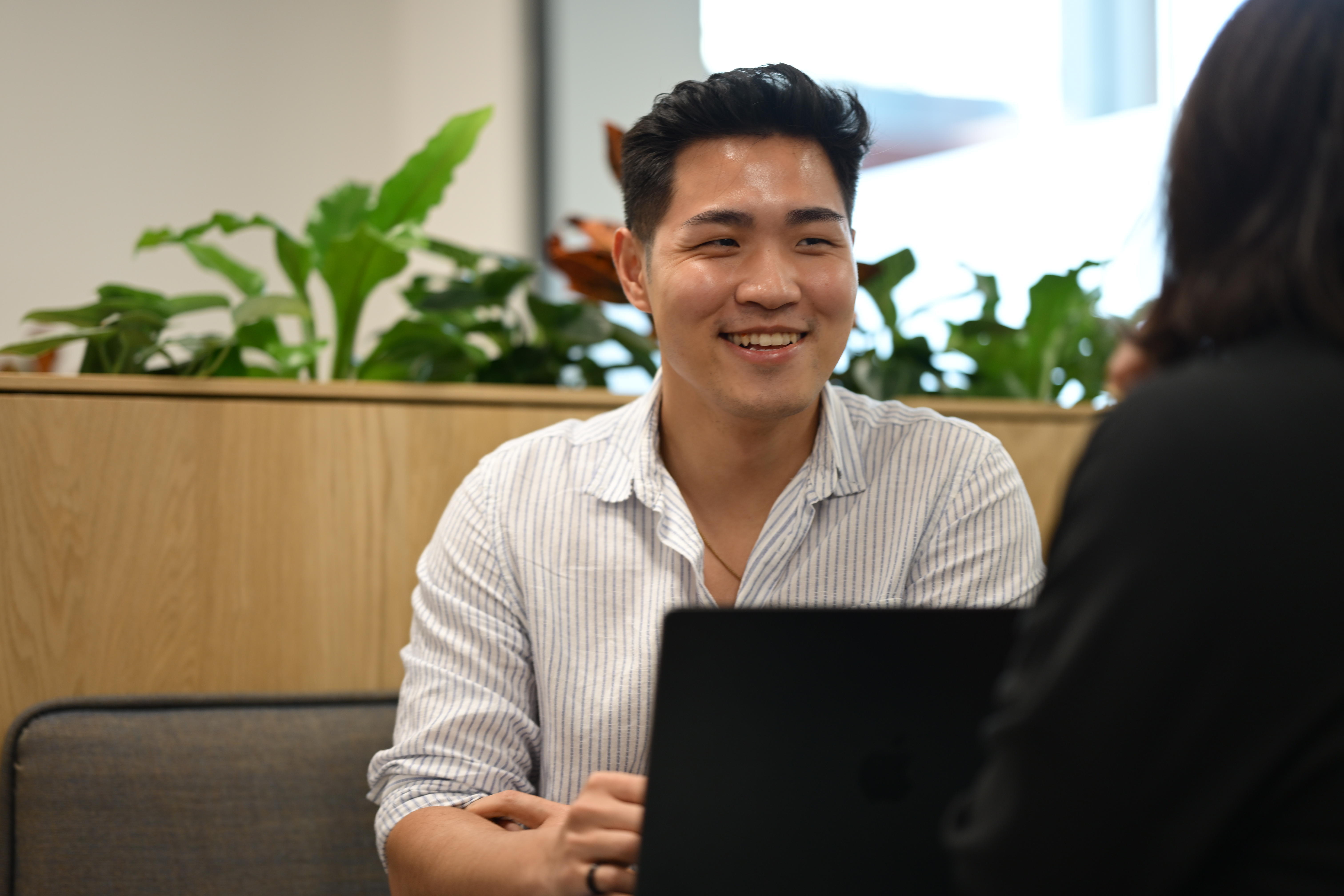 Person smiling and engaging in conversation.