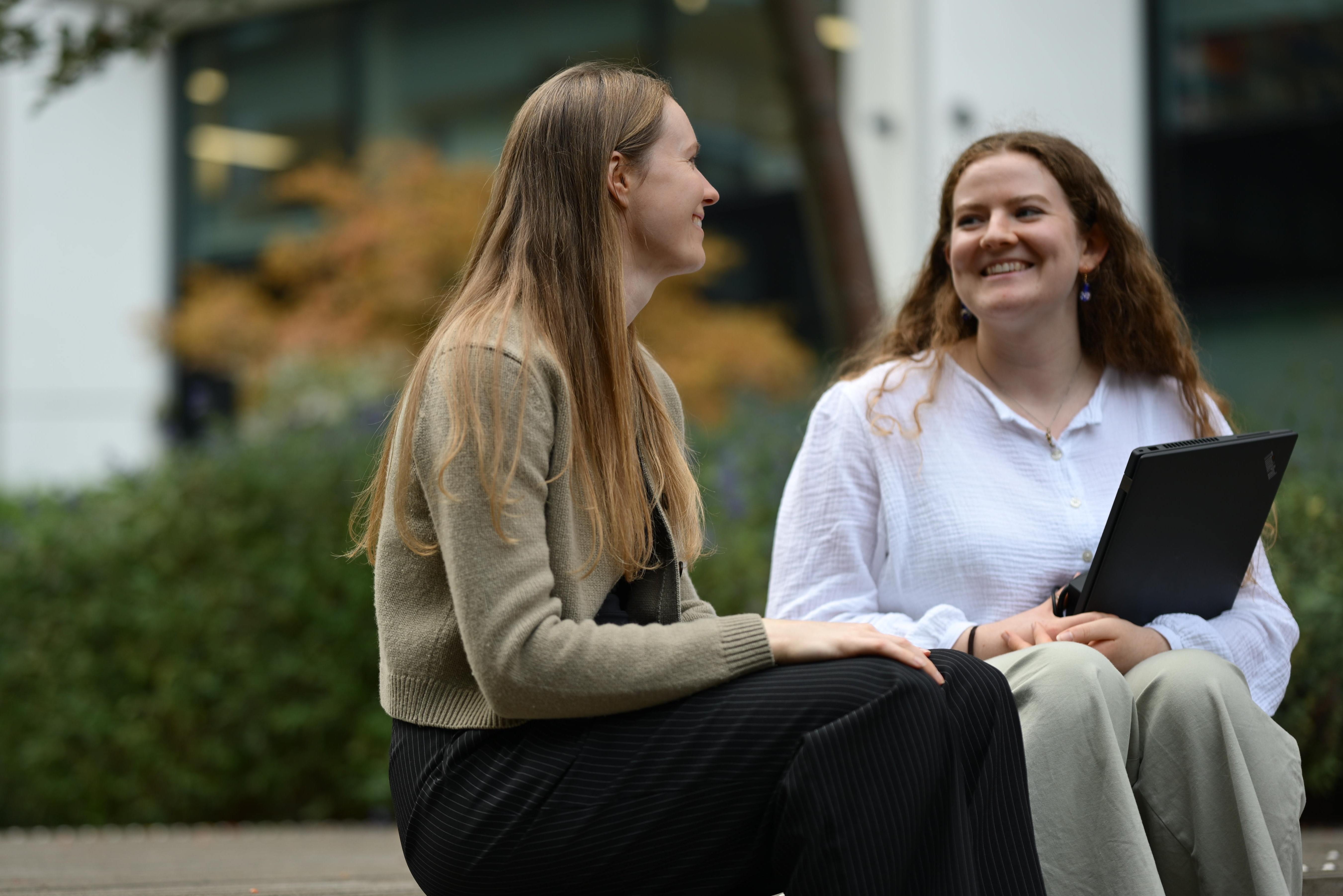 Two people sitting and talking.