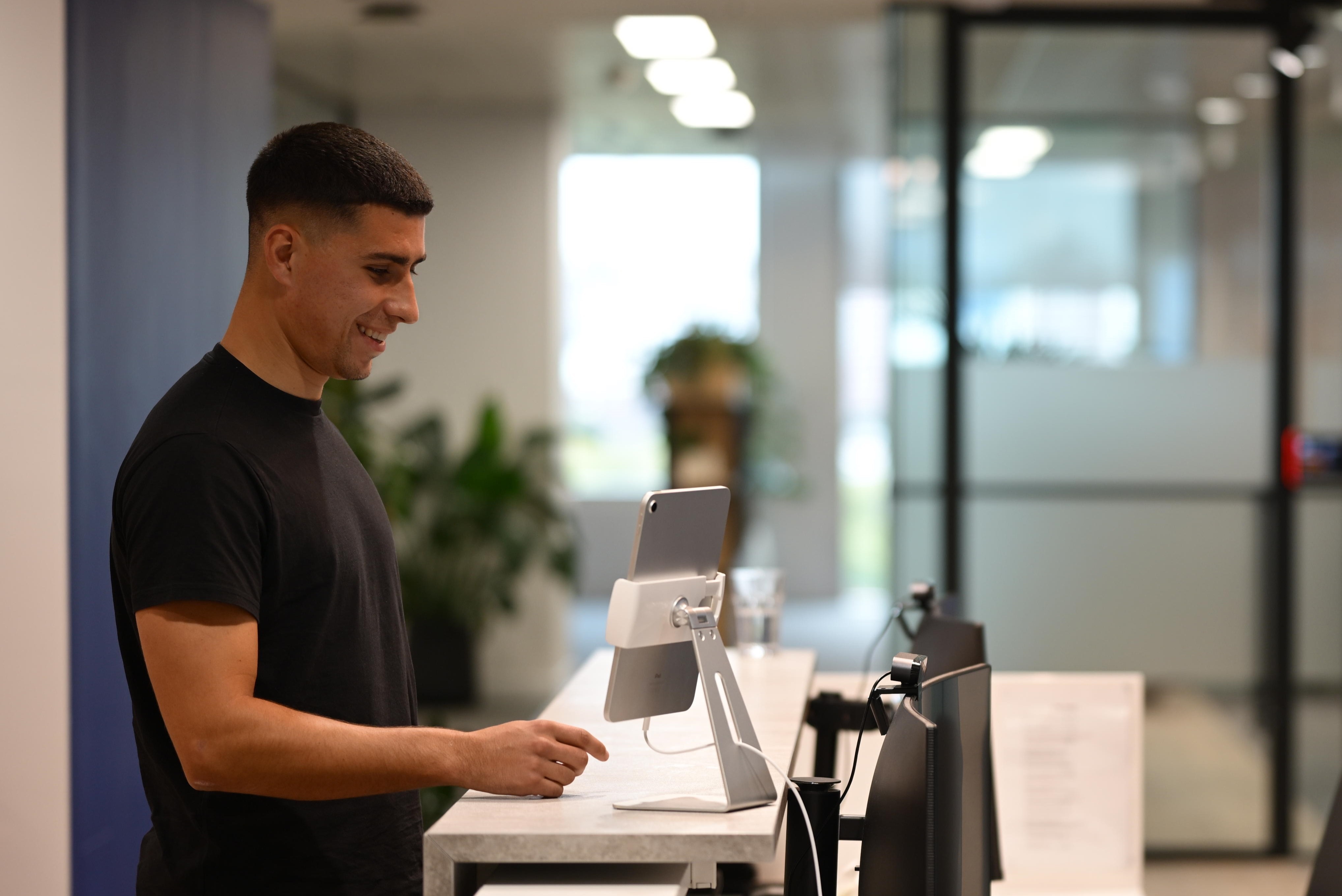 Person fills out form on tablet device.