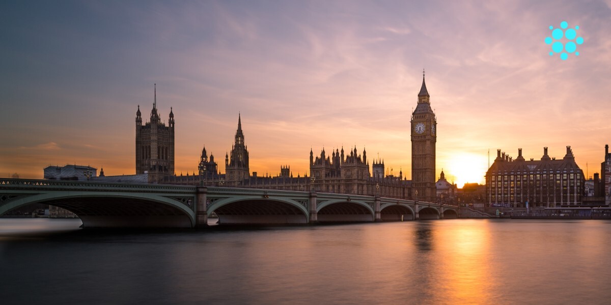A wide view of the Houses of Parliament against a sunset.