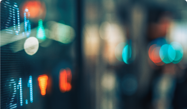 Blurred close up of colourful LED numbers and lights on an electronic display board.